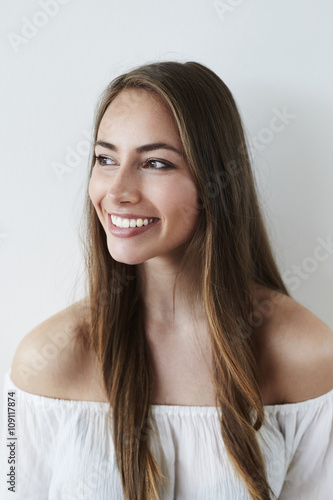 Stunning brown eyed girl looking away, smiling