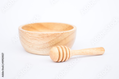 Wooden bowl and dipper on white background
