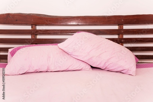 pink pillow on bed