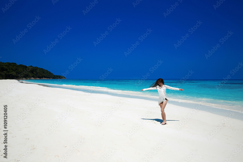 Enjoyment. Carefree happy woman open arms on tropical beach, exo