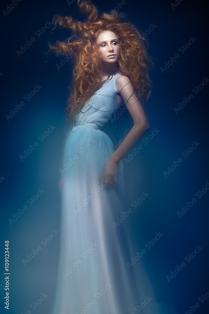 Beautiful fashionable red-haired girl in transparent dress, mermaid image with creative hairstyle curls. Fashion beauty style. Beautiful fashionable red-haired girl in transparent dress, mermaid image with creative hairstyle curls. Fashion beauty style.