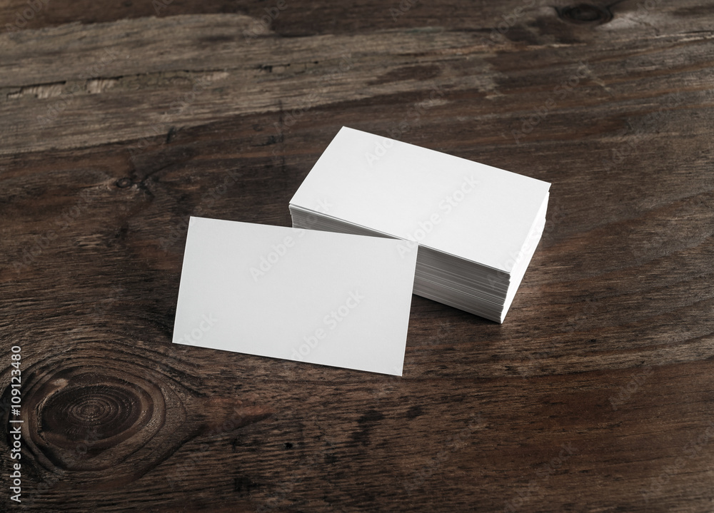 Blank white business cards on dark wooden background. Mockup for branding identity for designers. Blank white business cards on dark wooden background. Mockup for branding identity for designers.