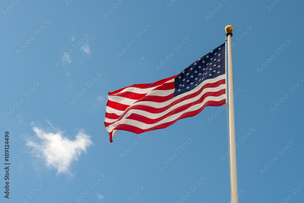 Bandiera Americana che sventola sul pennone nel cielo azzurro