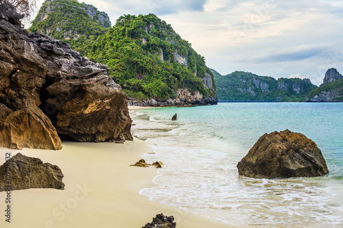 tropical beach with rocks on a summer day