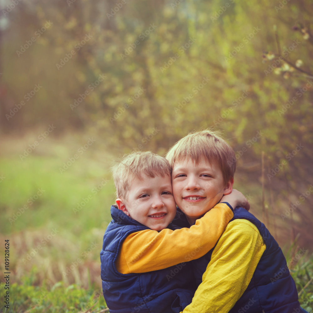 Portrait happy two brothers embracing in sunny day. Portrait happy two brothers embracing in sunny day.