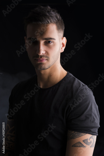 Young man with black t-shirt and tattoos