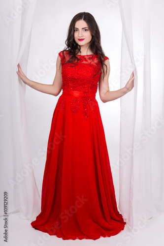 full length portrait of beautiful woman in red dress