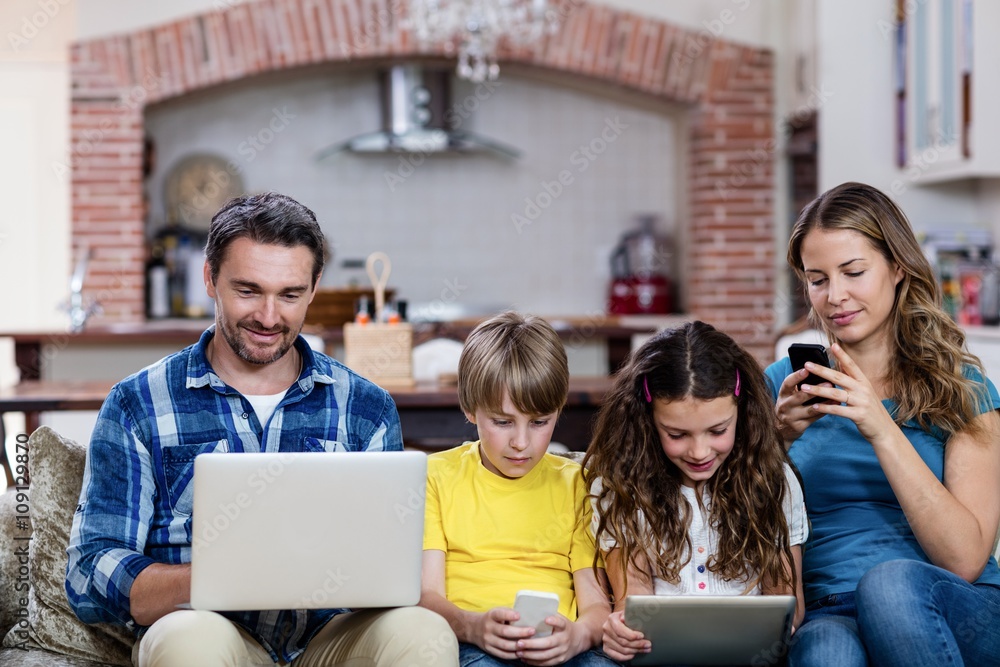 Parents and kids using a laptop, tablet and phone Parents and kids using a laptop, tablet and phone