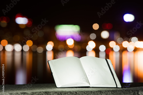Notebook on the background of the city at night