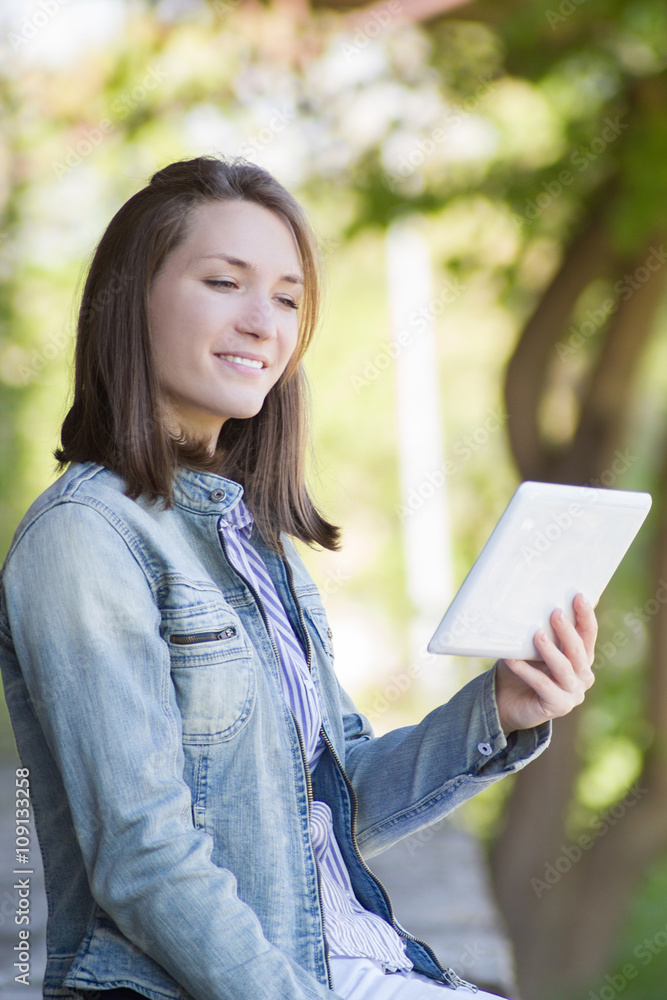 Excited young woman reading digital tablet outdoor Excited young woman reading digital tablet outdoor