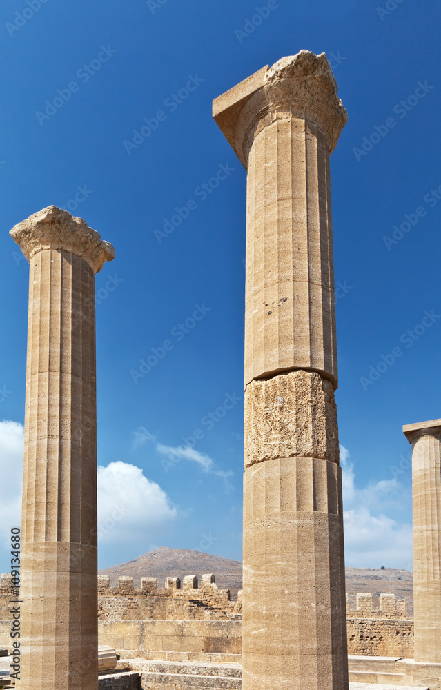 Columns in ancient Acropolis of Lindos against the blue sky, Rhodes, Greece