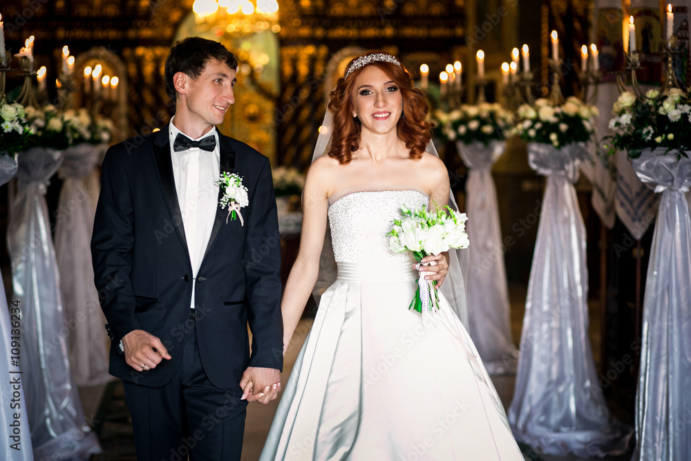 Fototapeta premium Bride and groom is going out the church