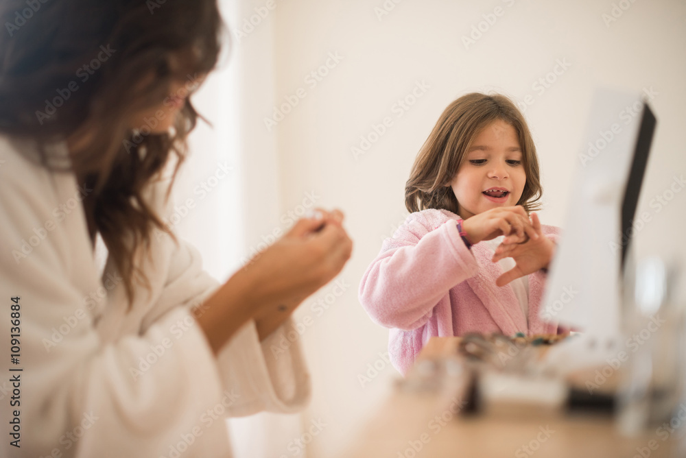 Daughter playing with her mother jewellery Daughter playing with her mother jewellery