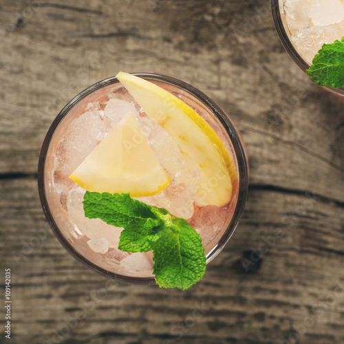 Summer cocktail with ice, lemon, apple and mint photo