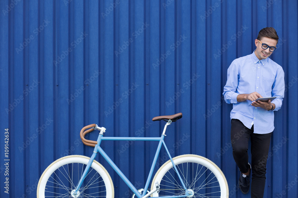Modern man with tablet and bike Modern man with tablet and bike