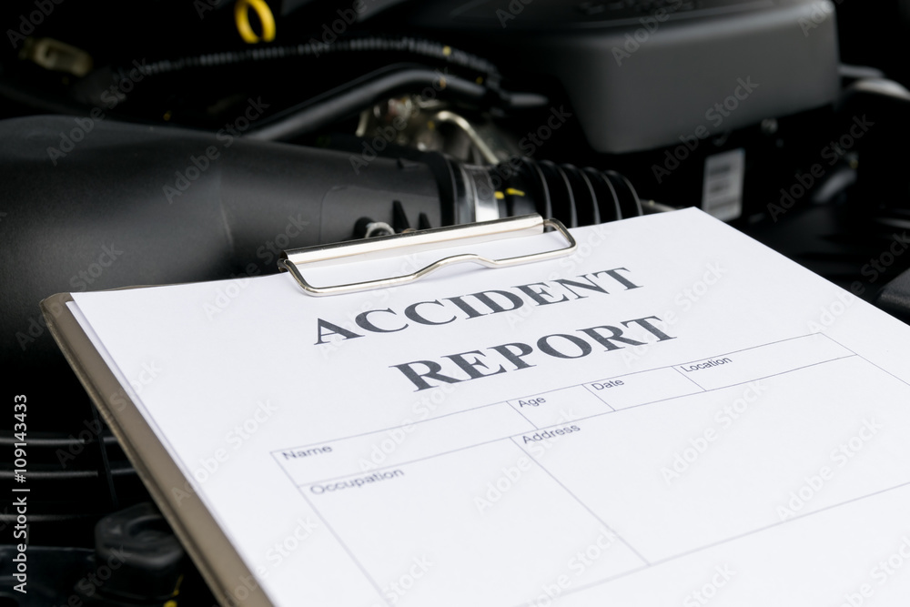 Mechanic Inspecting damage car and filling in accident report fo Mechanic Inspecting damage car and filling in accident report fo