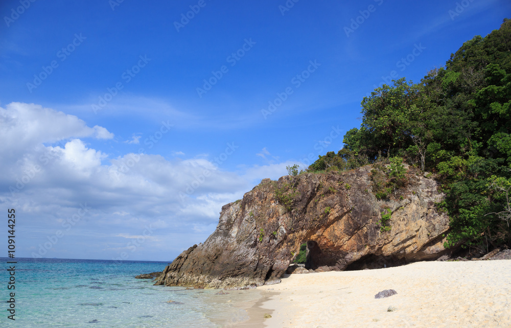 clear water sea and rough rock stone at Tropical white bay beach with sunset nature composition