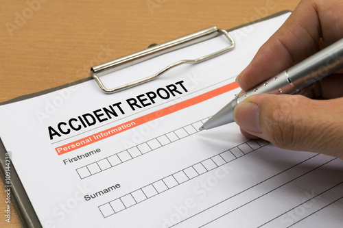 man signing a accident report form