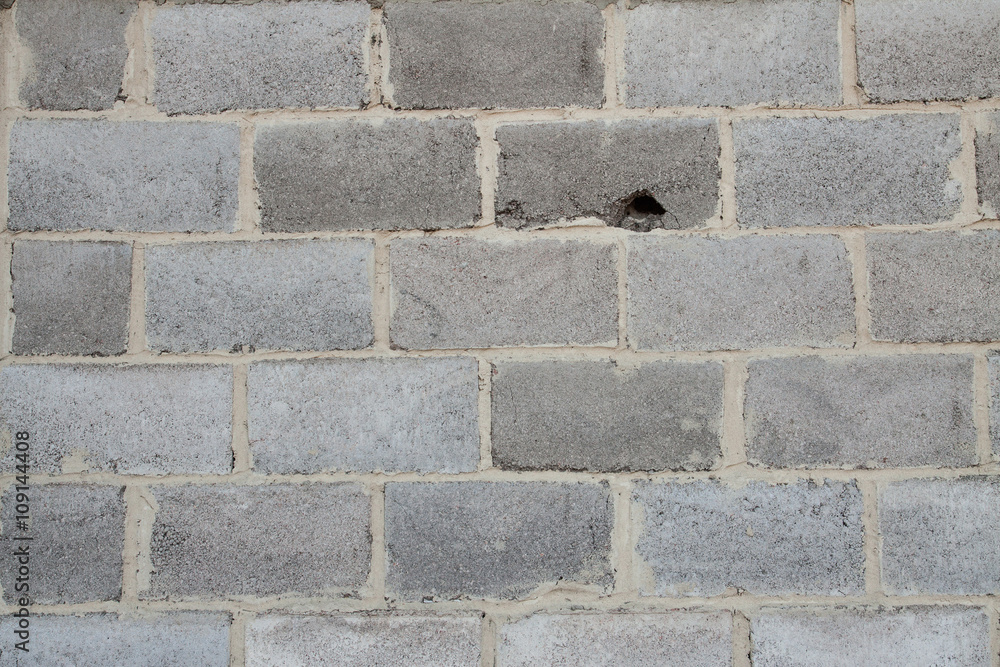 grey brick wall with close up. hole in the wall. rocky background grey brick wall with close up. hole in the wall. rocky background