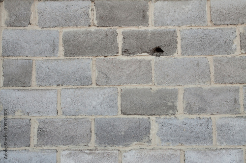 grey brick wall with close up. hole in the wall. rocky background