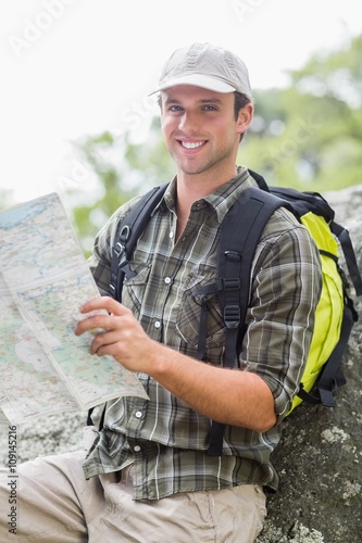 Portrait of young hiker with map
