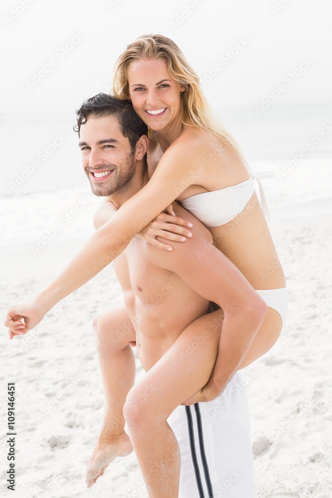 Boyfriend giving piggy back to girlfriend