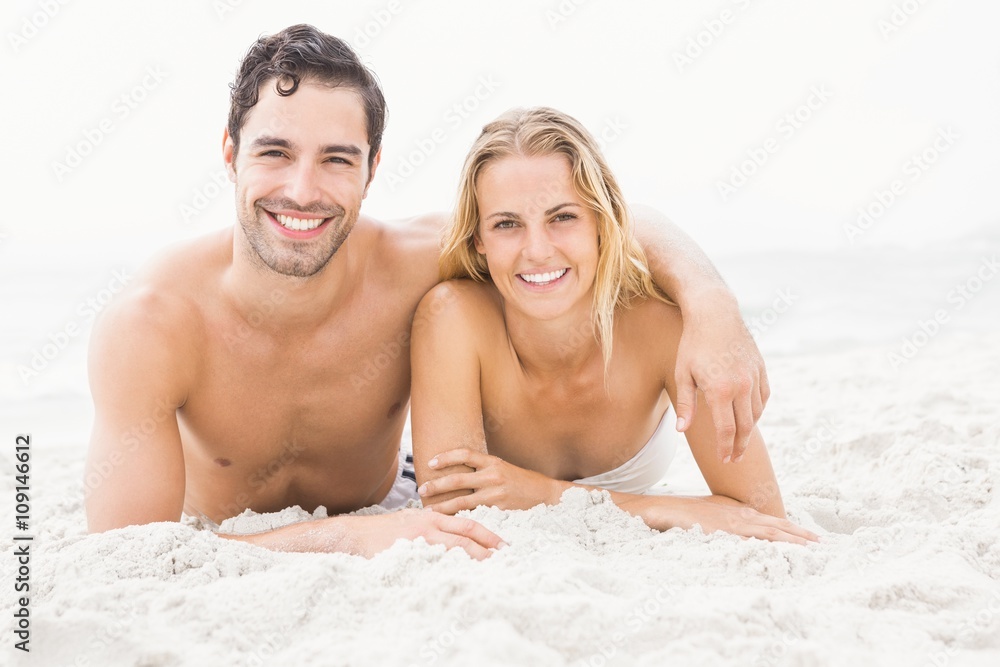 Happy couple lying on the beach Happy couple lying on the beach