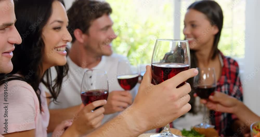 Happy friends cheering with red wine Happy friends cheering with red wine