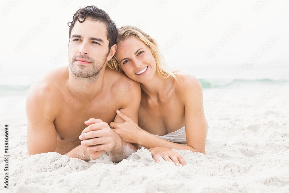 Happy couple lying on the beach Happy couple lying on the beach