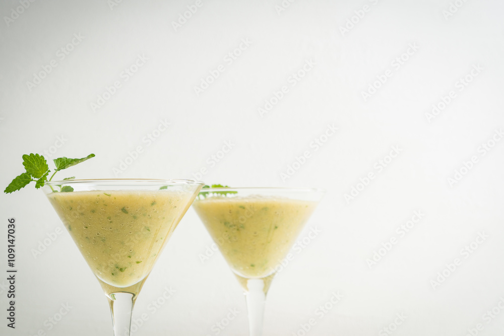 Fresh banana cocktail with mint on the wooden background