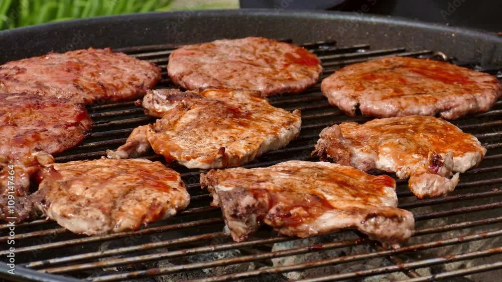 Person putting sauce on burgers and steaks Person putting sauce on burgers and steaks