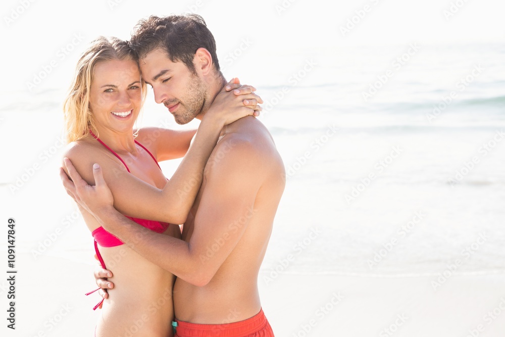 Happy couple embracing on the beach Happy couple embracing on the beach