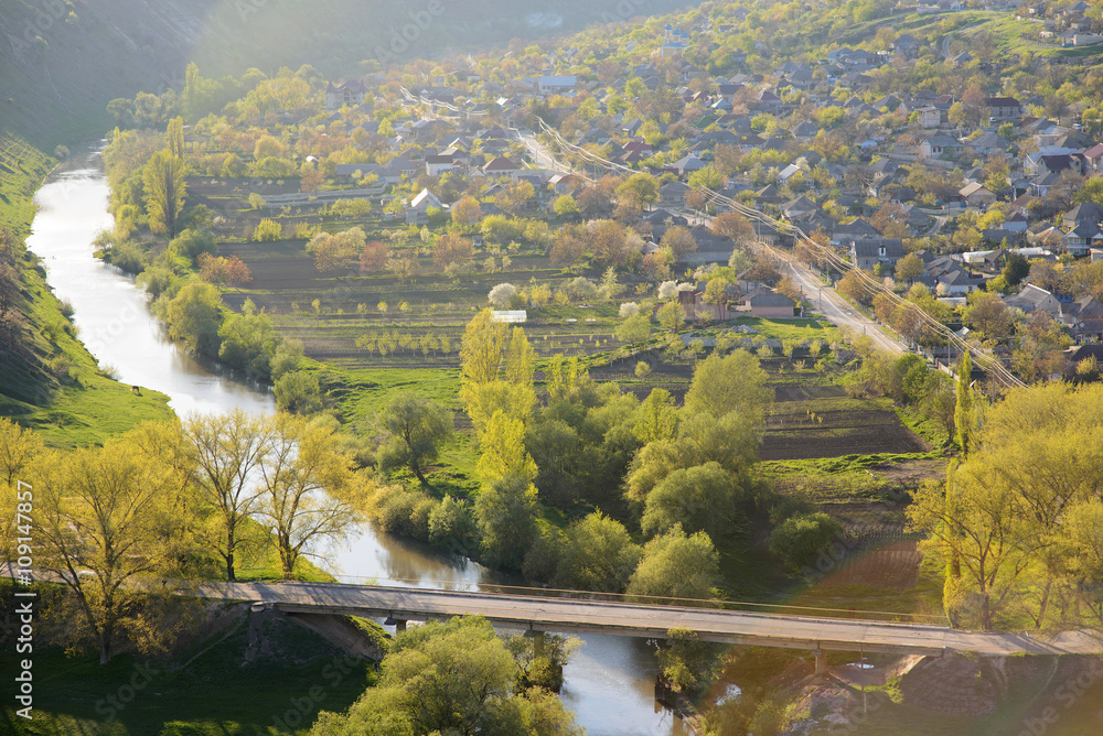 Naklejka premium Sunset Village and River