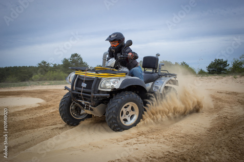 Racing ATV is sand.
