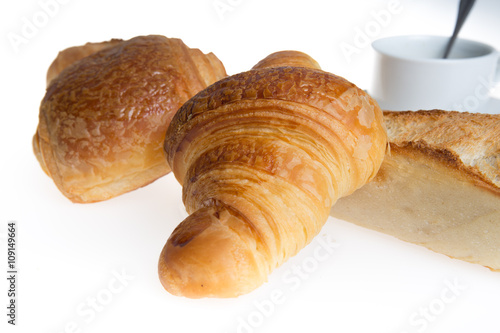 Cup of coffee with french croissant and chocolatine with bread