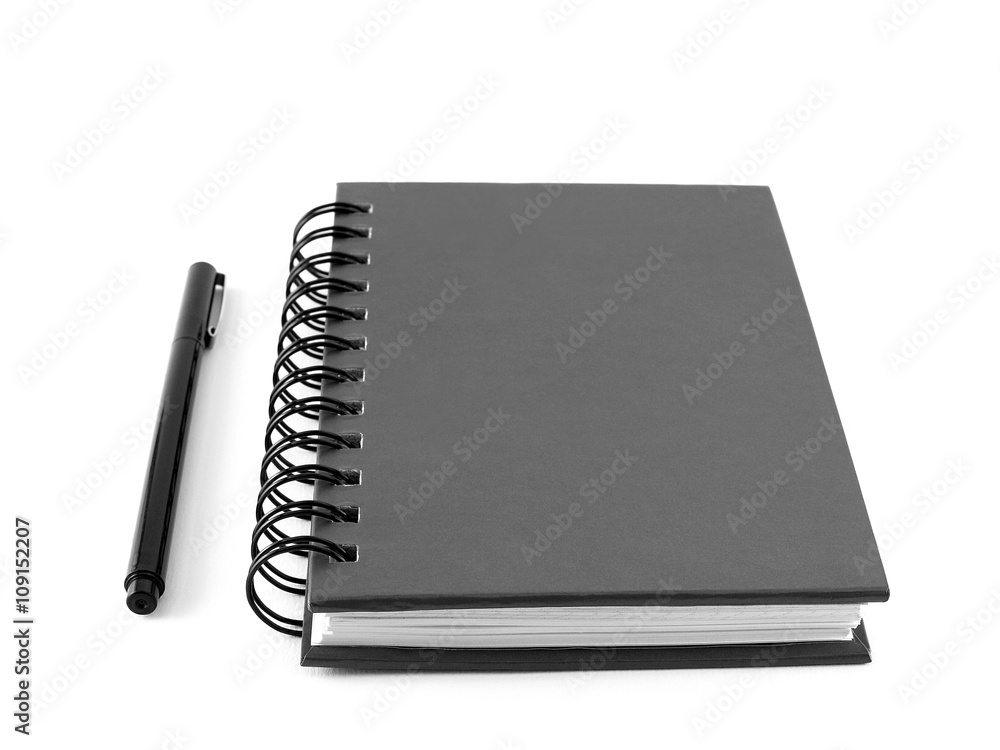close-up closed black cardboard cover notebook with pen isolated on white close-up closed black cardboard cover notebook with pen isolated on white