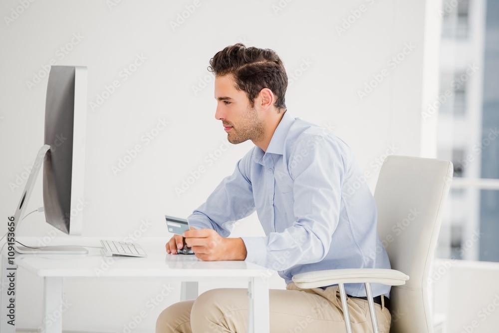 Businessman doing online shopping on computer Businessman doing online shopping on computer