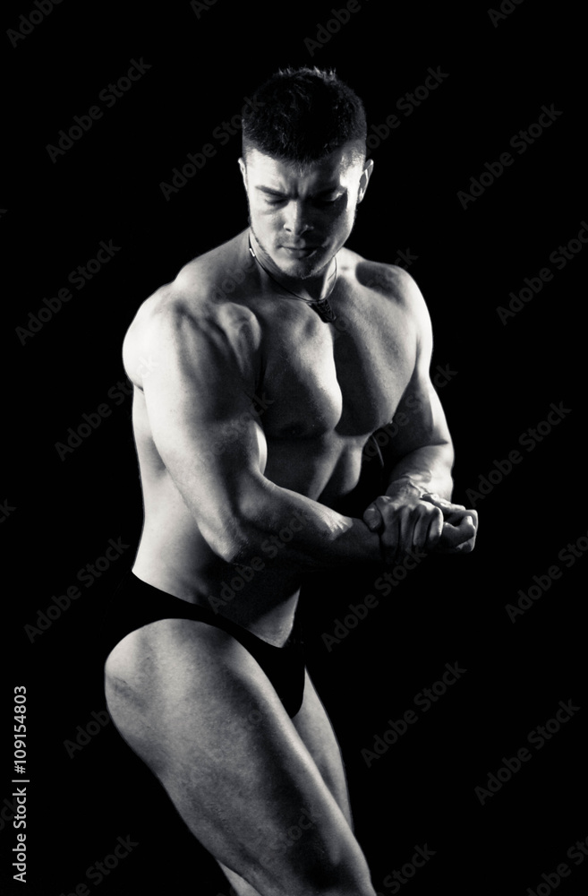 Bodybuilder showing his back and biceps muscles, personal fitness trainer. Strong man flexing his muscles Bodybuilder showing his back and biceps muscles, personal fitness trainer. Strong man flexing his muscles
