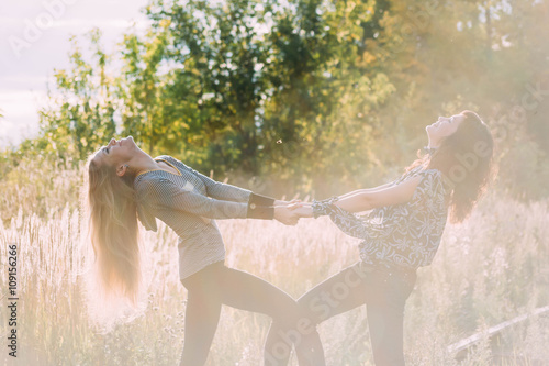 two Young women walking on railway tracks near train