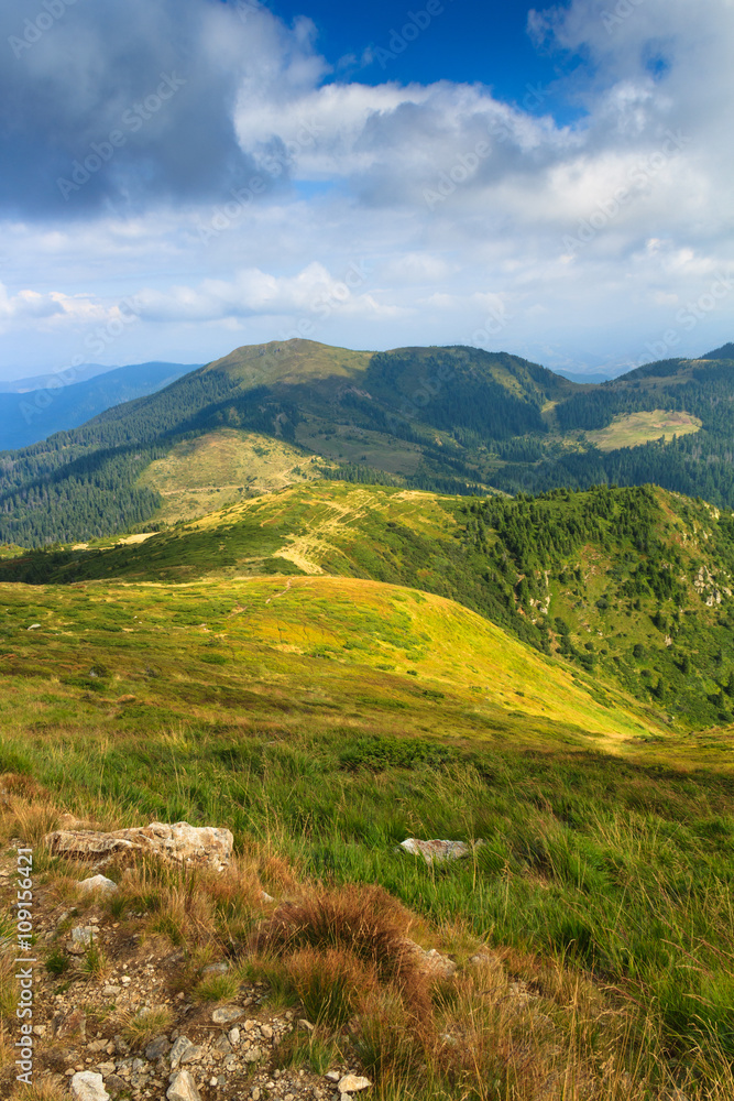 Fototapeta premium View of panoramic mountains landscape of a rocky cliffs and green hills.