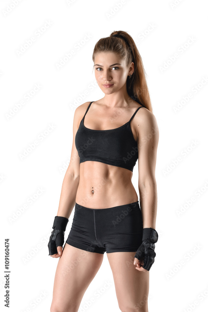 Cutout fitness lady showing torso stands and looks directly at the camera Cutout fitness lady showing torso stands and looks directly at the camera