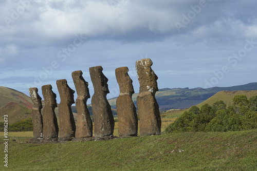 Ahu Kivi. Ancient Moai statues set amongst green fields and facing the sea on Rapa Nui (Easter Island)