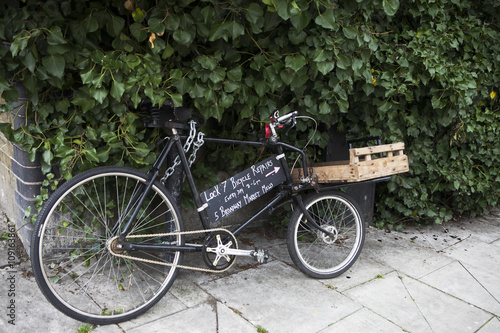  One of the many rental shops and repair bicycles in the streets of the old town. Sign with the name of repair bicycles