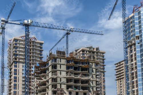 The complex of buildings under construction and cranes