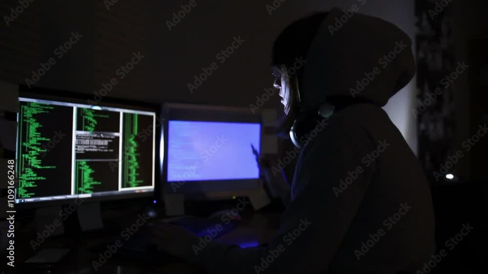 hacker girl works at the computer and smoking electronic cigarette hacker girl works at the computer and smoking electronic cigarette