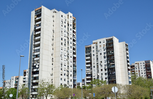 Line of residential buildings under clear spring sky
