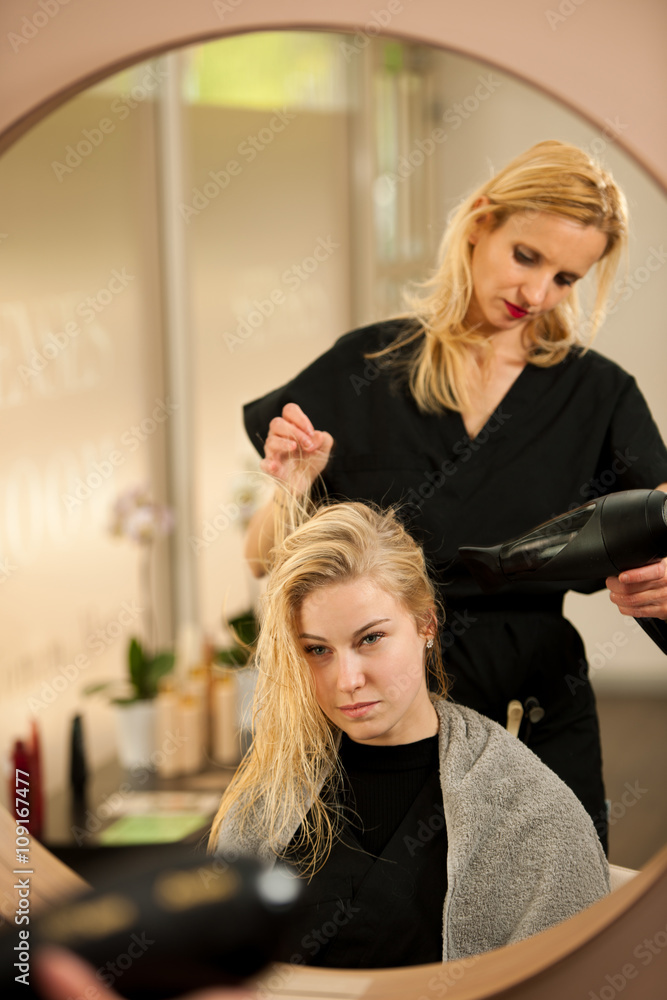 professional hair stylist at work - hairdresser  doing hairstyle