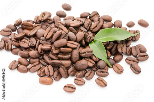 Coffee grains and leaves isolated on the white backgrounds.