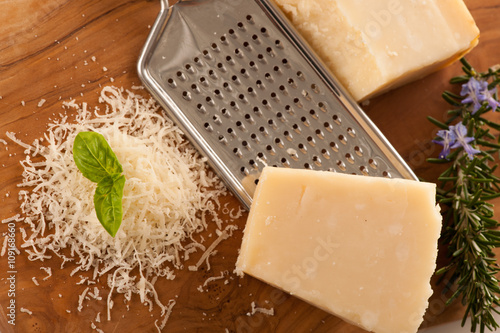 Parmesan cheese on wooden  plate isolated over white background