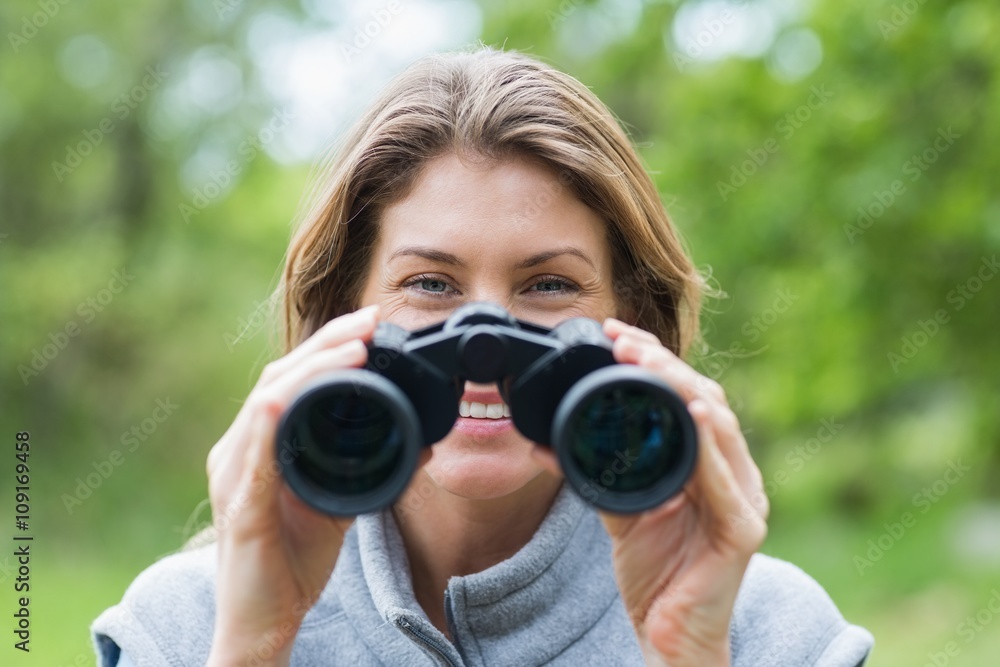 Close-up of smiling woman with binoculars Close-up of smiling woman with binoculars